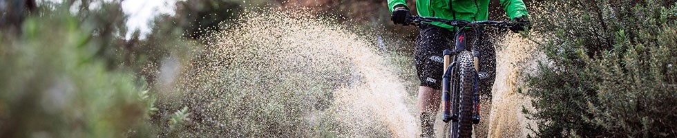 mountain biker riding through water